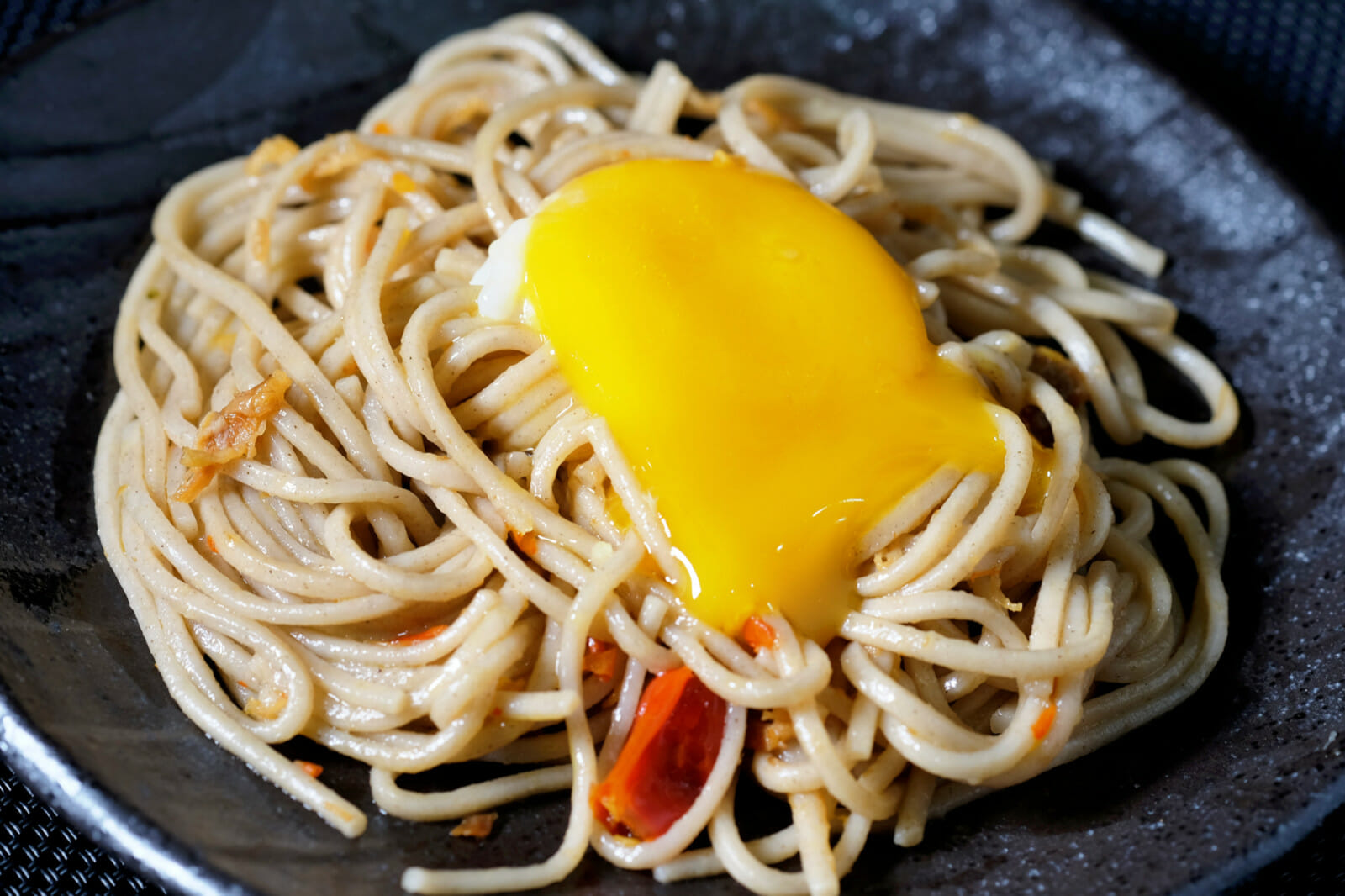 Spicy soba noodles with XO sauce and confit egg yolk - delectabilia